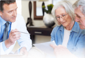 Doctor points to a document with elderly couple