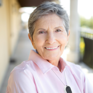 remote patient monitoring devices pendant on woman in pink shirt